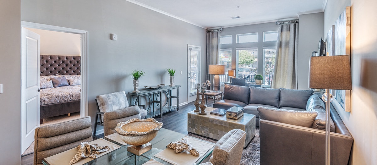 a living room with a couch and a table     and a bedroom