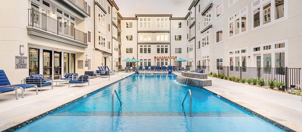 a large swimming pool in the middle of an apartment building