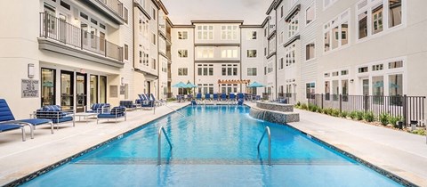 a large swimming pool in the middle of an apartment building