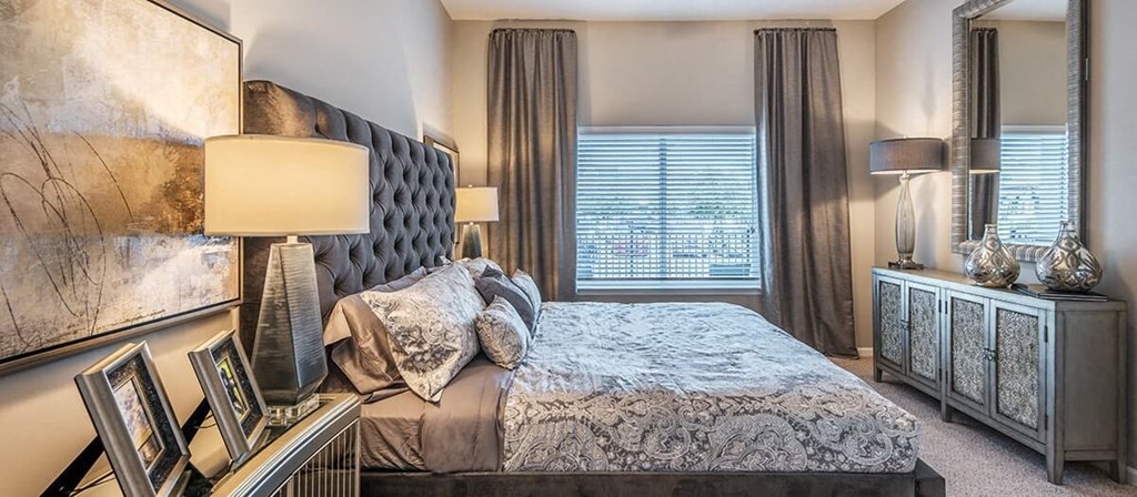 a bedroom with a large bed and a window