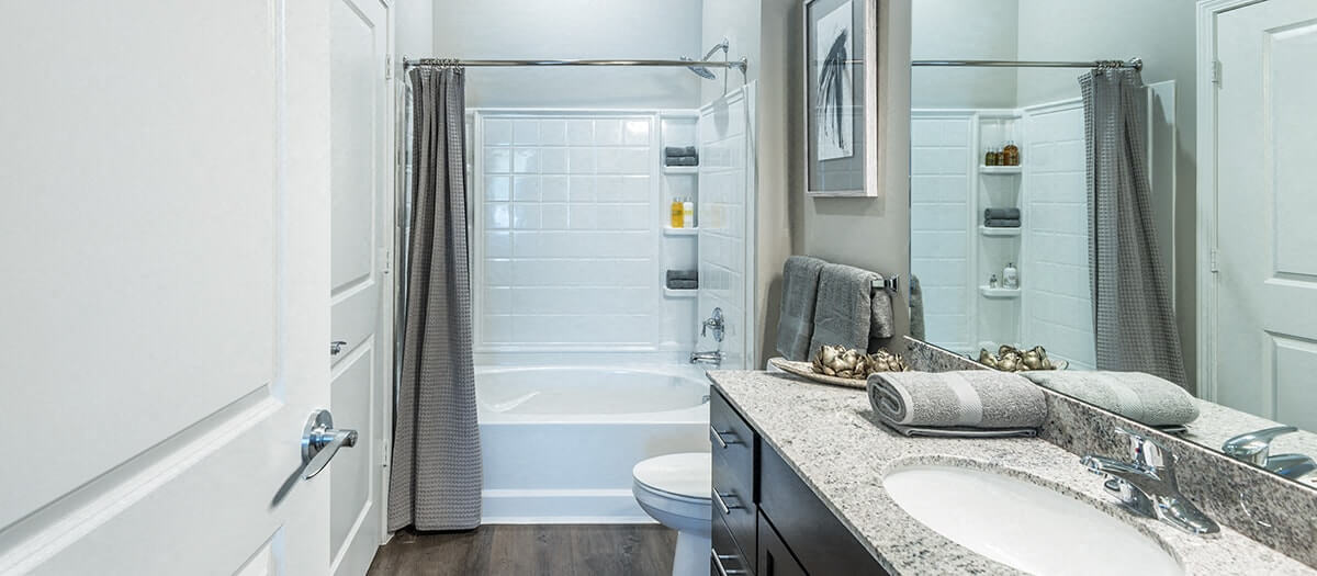 a bathroom with a shower and a sink and a toilet