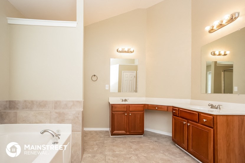 a bathroom with two sinks and a large mirror