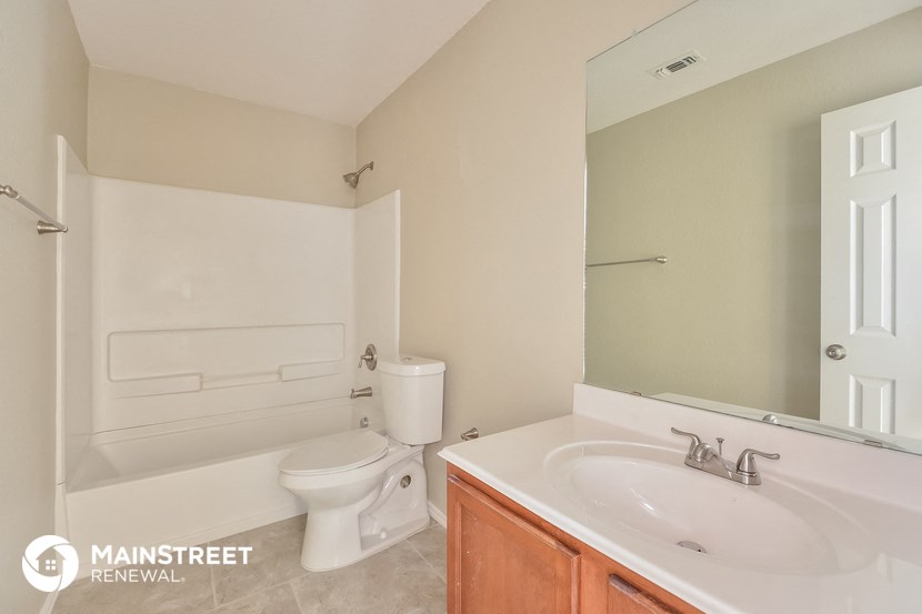 a bathroom with a sink and a toilet and a mirror