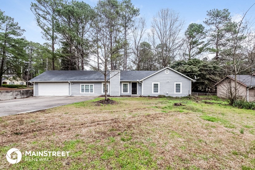 a white house with a yard in front of it