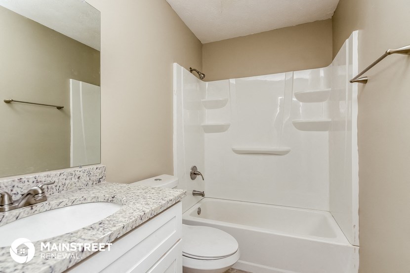 a bathroom with a shower and a sink and a toilet
