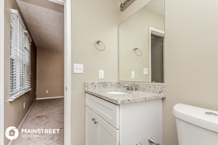 a bathroom with a sink and a mirror and a toilet