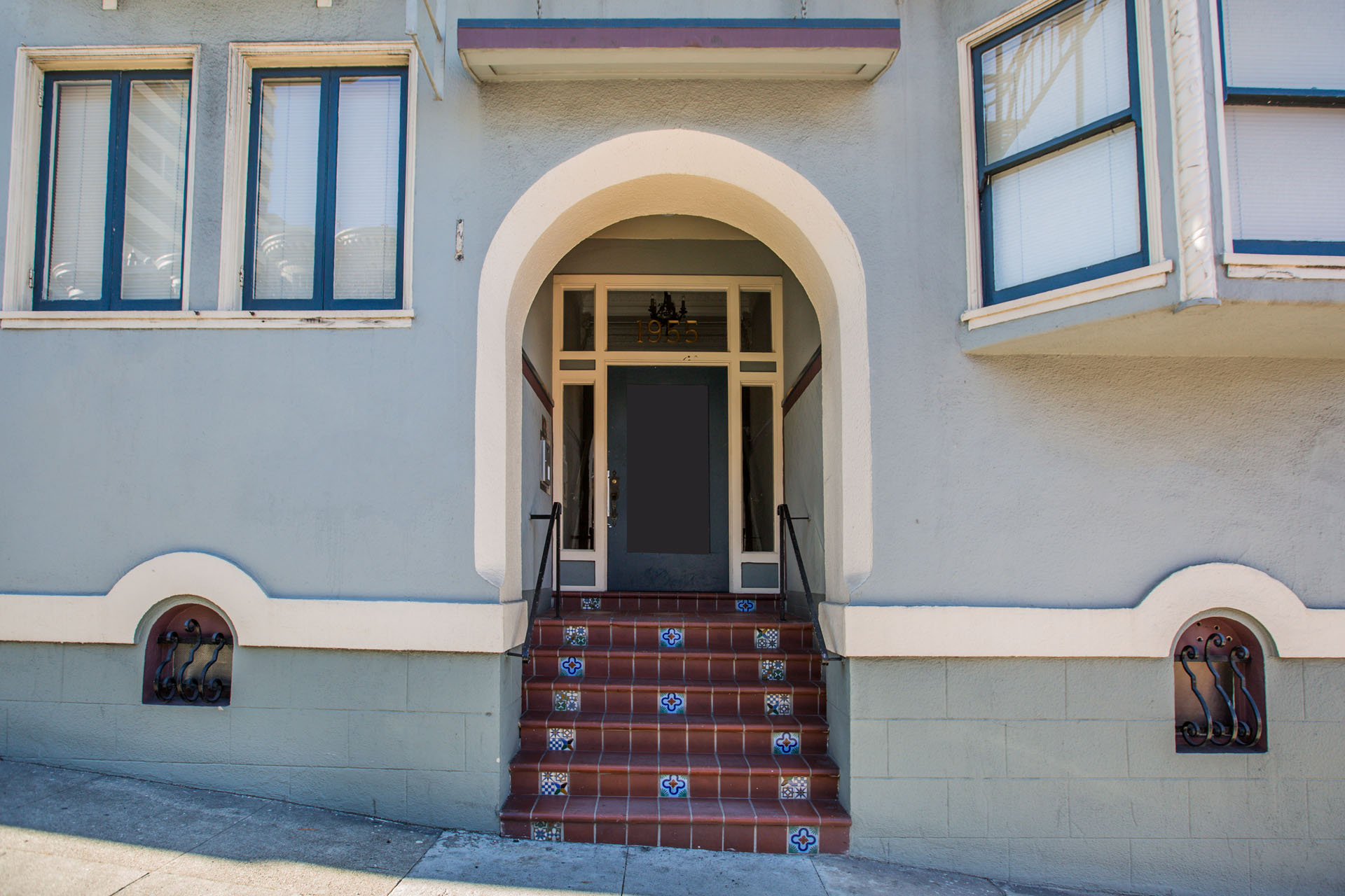 A building with a white door and steps leading up to it.
