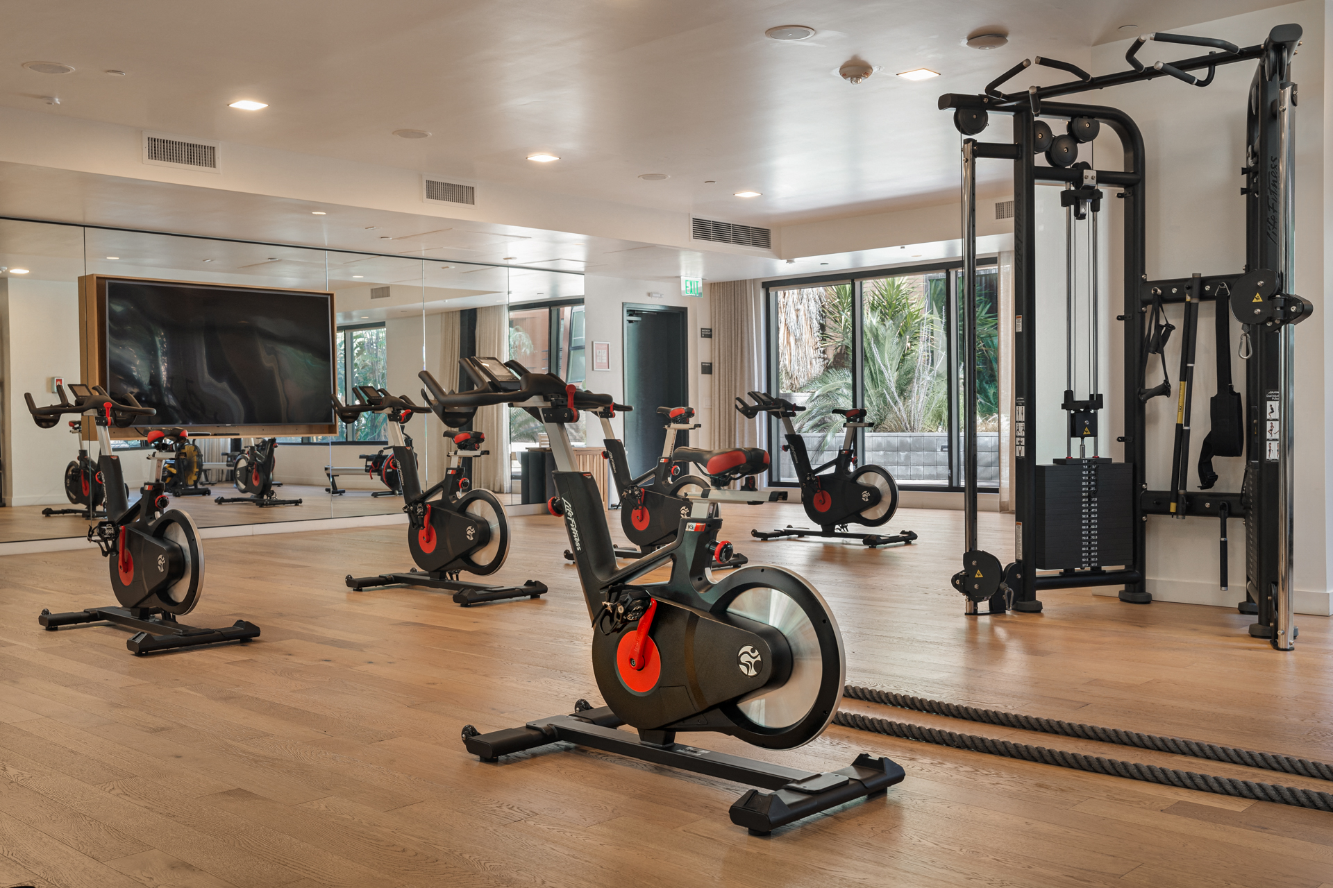 a home gym filled with exercise bikes and a tv