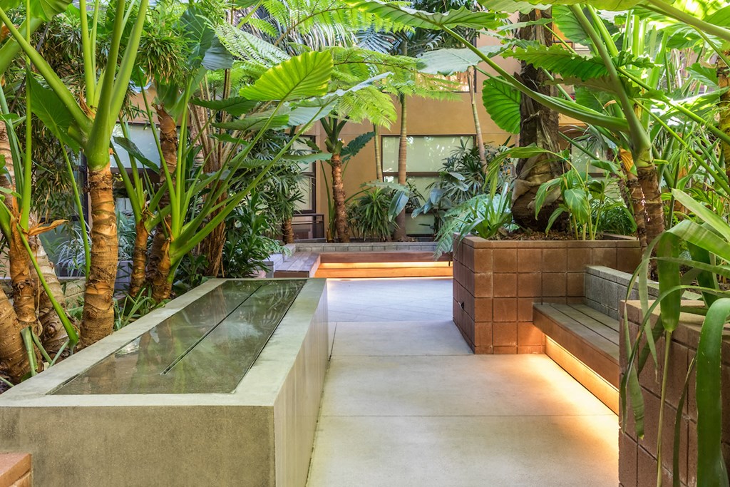 the lobby or reception area of a hotel with plants