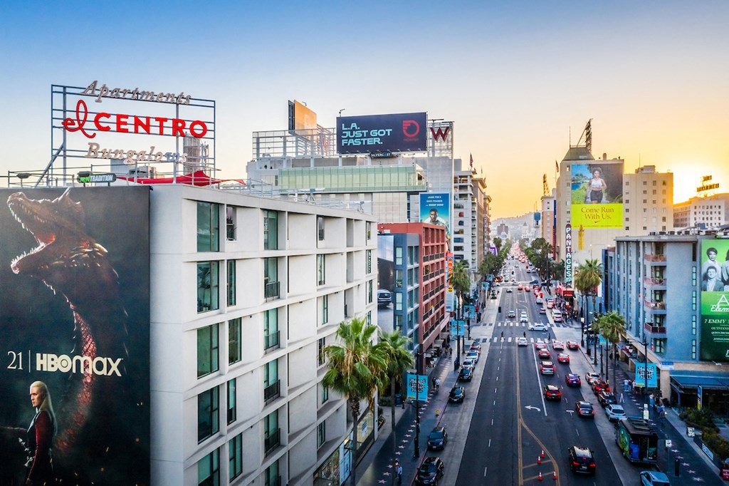 a busy city street with cars and tall buildings