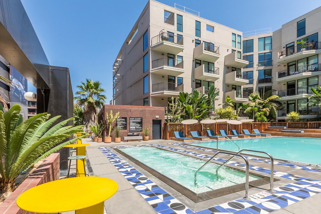 a swimming pool in front of an apartment building