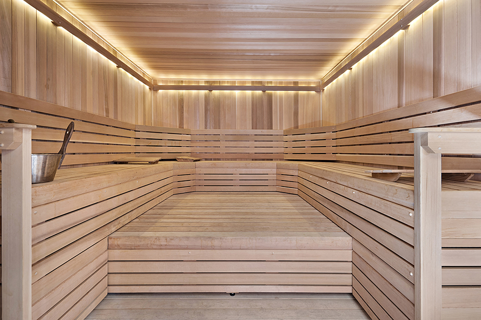a large wooden sauna in a home gym