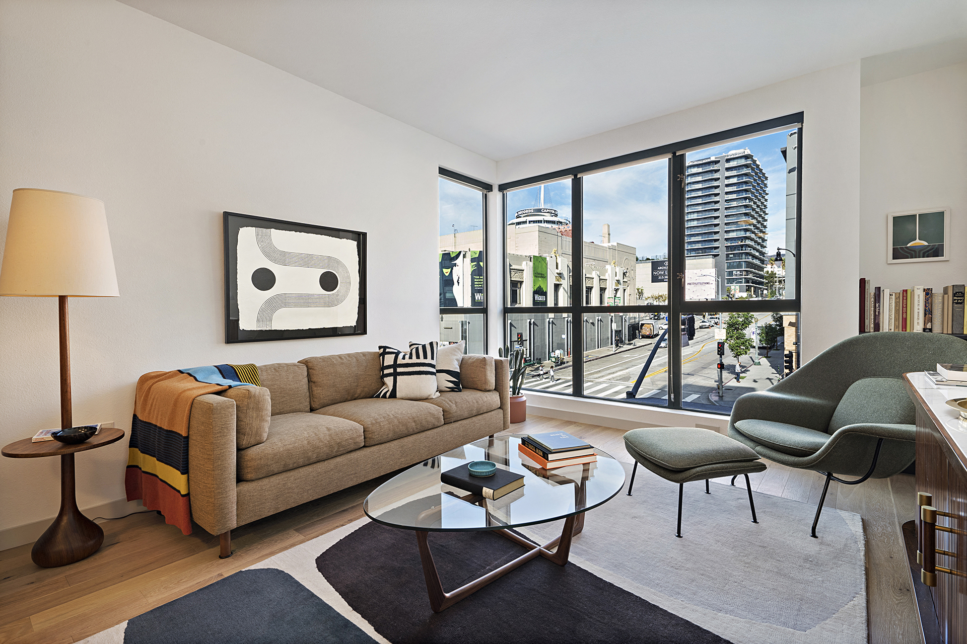 a living room with a couch and a view of the city