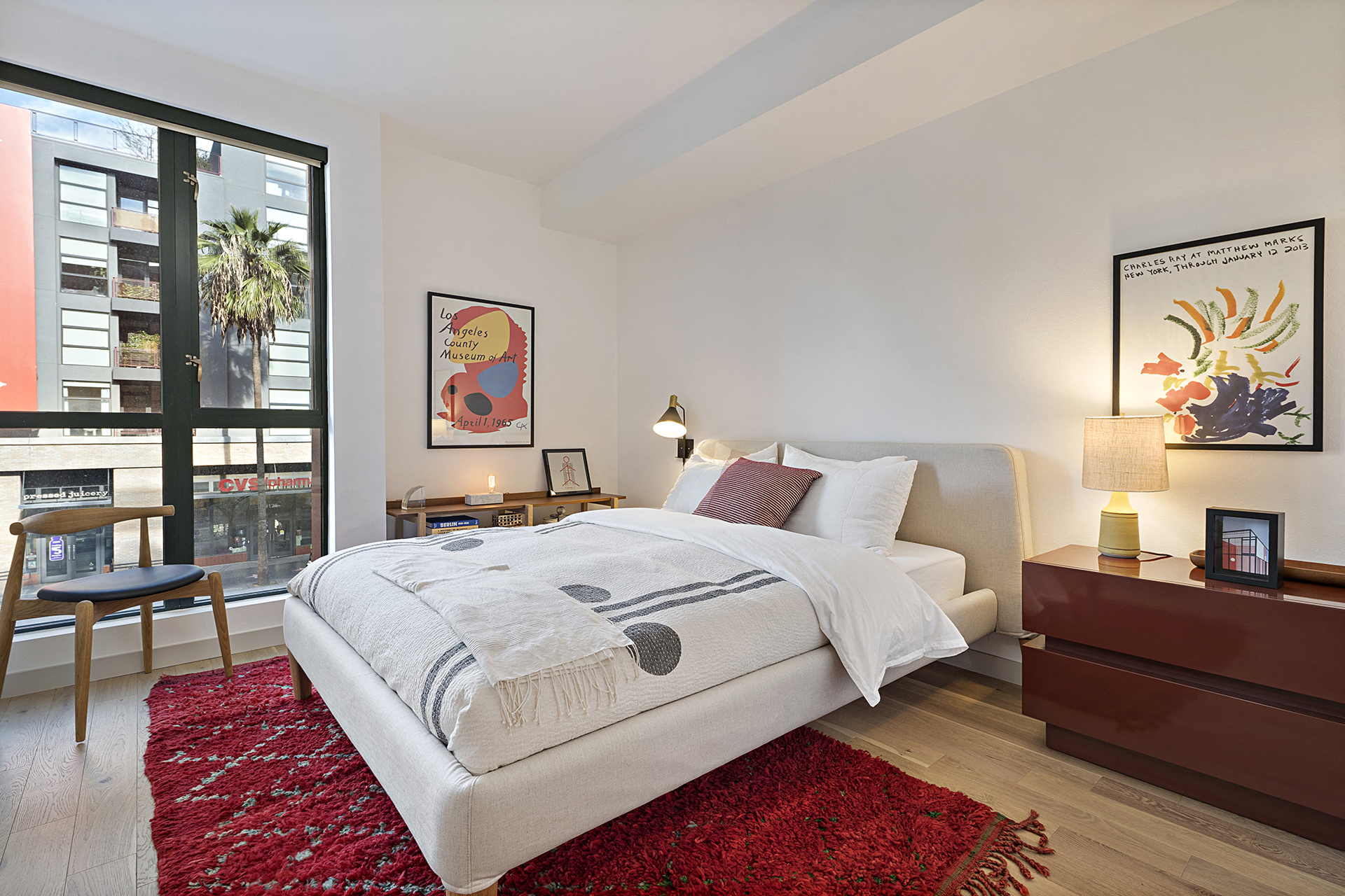 a bedroom with a bed and a large window