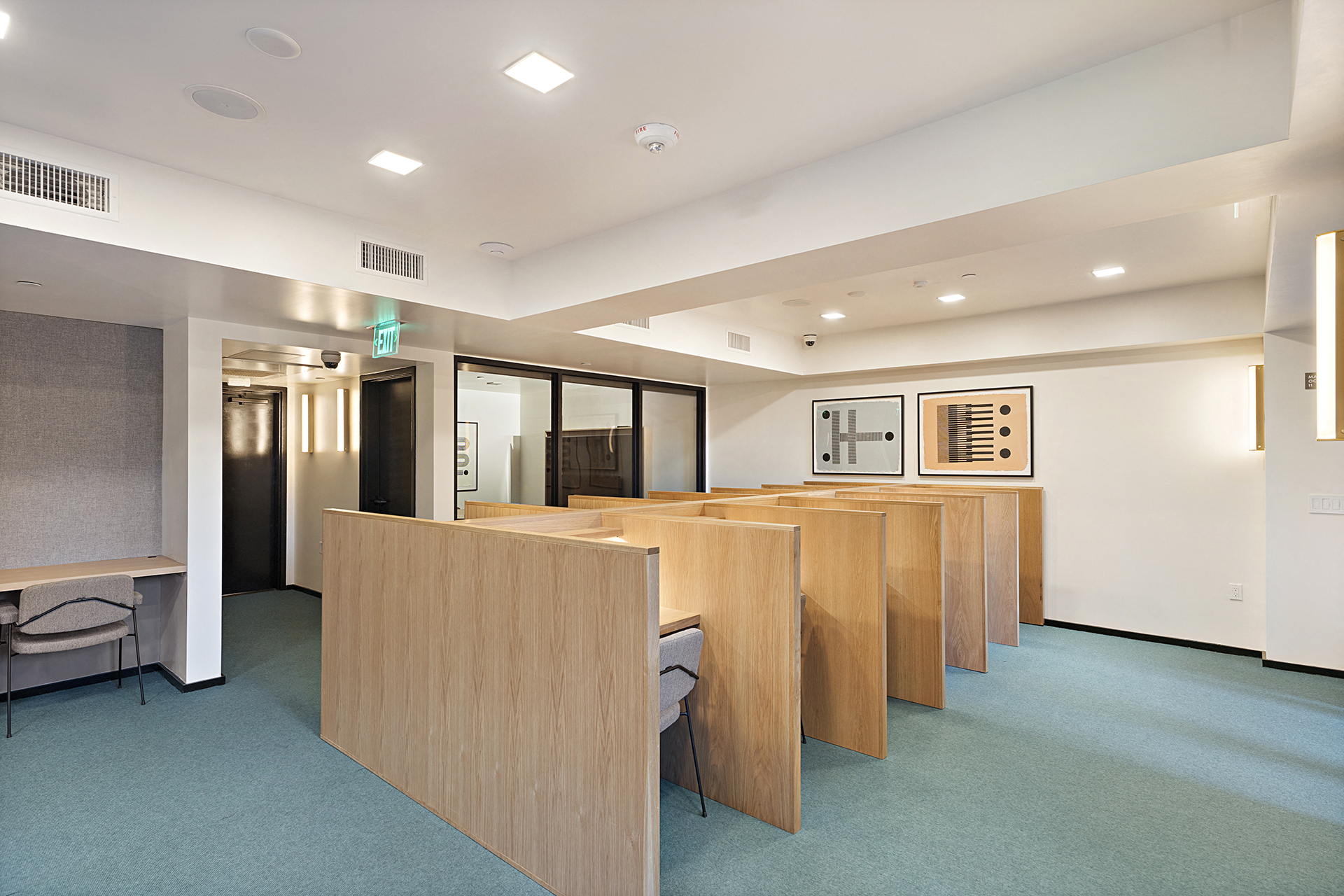 a seating area in a room with wooden desks and chairs