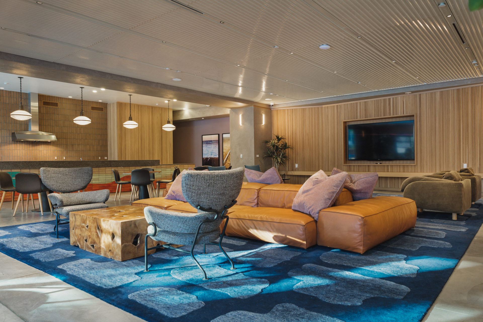 a living room with couches and chairs and a rug