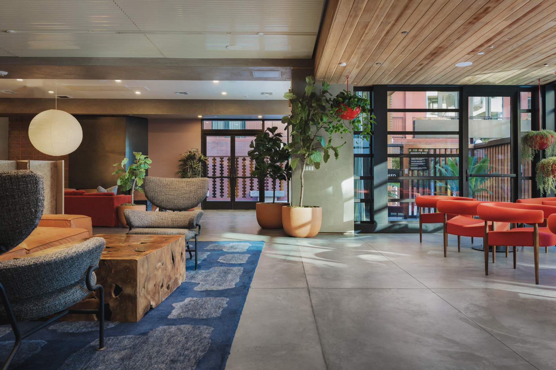 the lobby of a hotel with chairs and tables