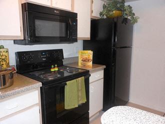 a kitchen with a black stove and a black refrigerator