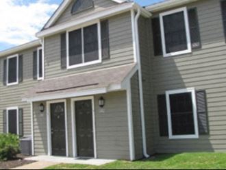 a gray house with white siding and a front porch