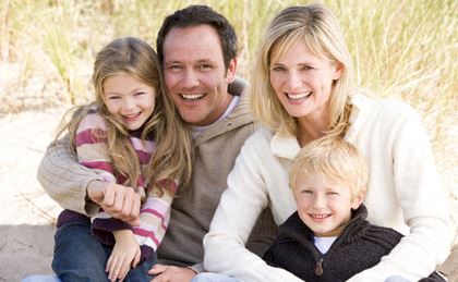 a family posing for a picture at the beach