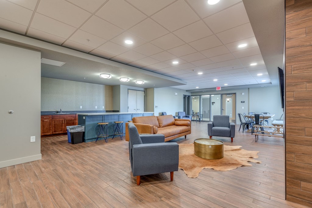 a lounge area with couches and chairs and a bar and tables in a lobby