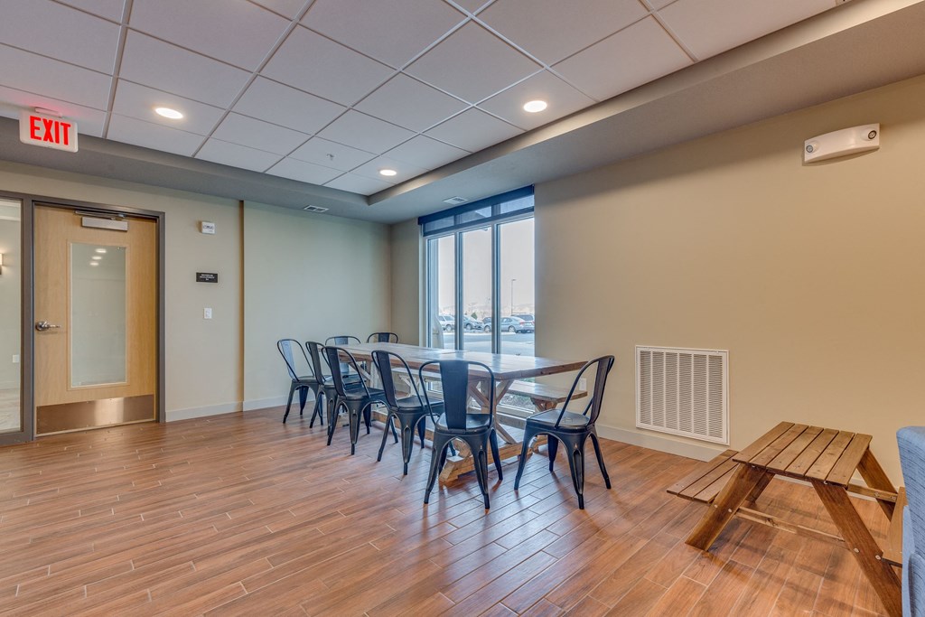 a conference room with a table and chairs and a window