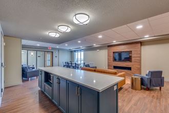 a kitchen with a counter and a living room with a tv
