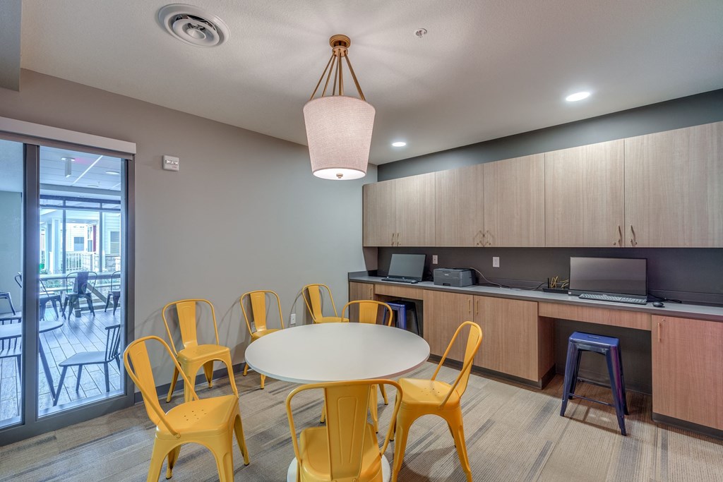 a dining room with a table and chairs and a kitchen
