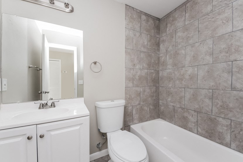 a bathroom with a sink toilet and a tub