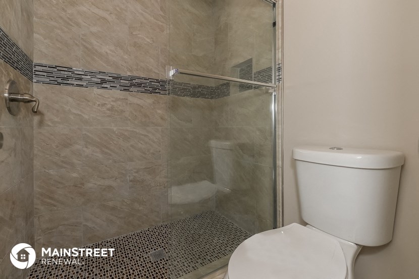 a small bathroom with a shower and a toilet