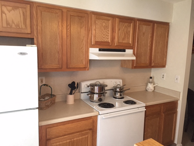 a kitchen with a stove and a refrigerator