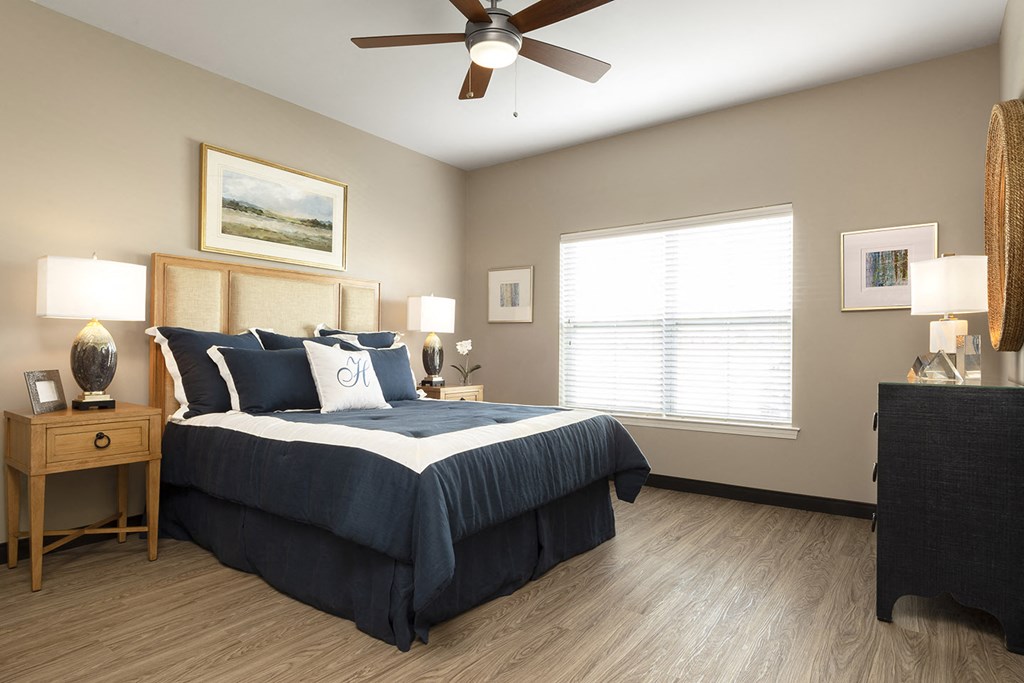 bedroom with light wood flooring and dark bed at Thirteen01 at Hartman Lakes, Shiloh, 62269