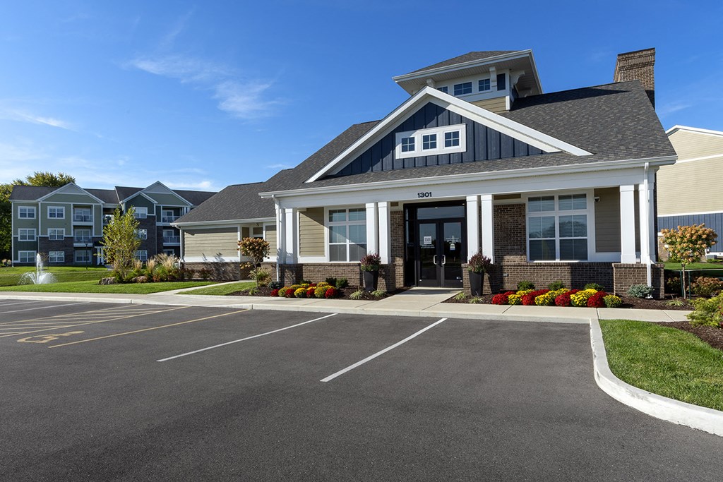 exterior clubhouse with parking in front at Thirteen01 at Hartman Lakes, Shiloh, IL