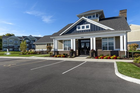 exterior clubhouse with parking in front exterior clubhouse with parking in front at Thirteen01 at Hartman Lakes, Shiloh, IL