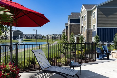 lounge chair under umbrella at Thirteen01 at Hartman Lakes, Shiloh, Illinois