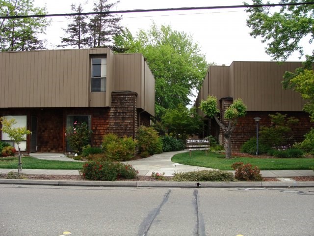 a house on a street with a sidewalk