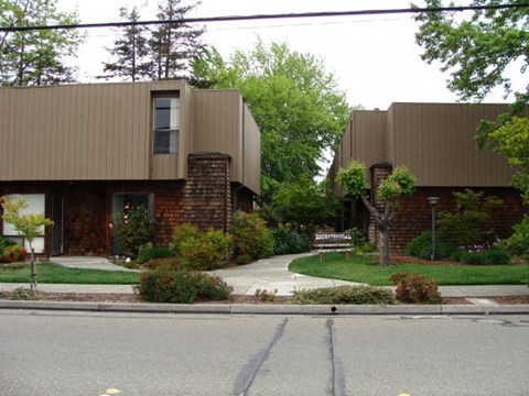a house on a street with a sidewalk