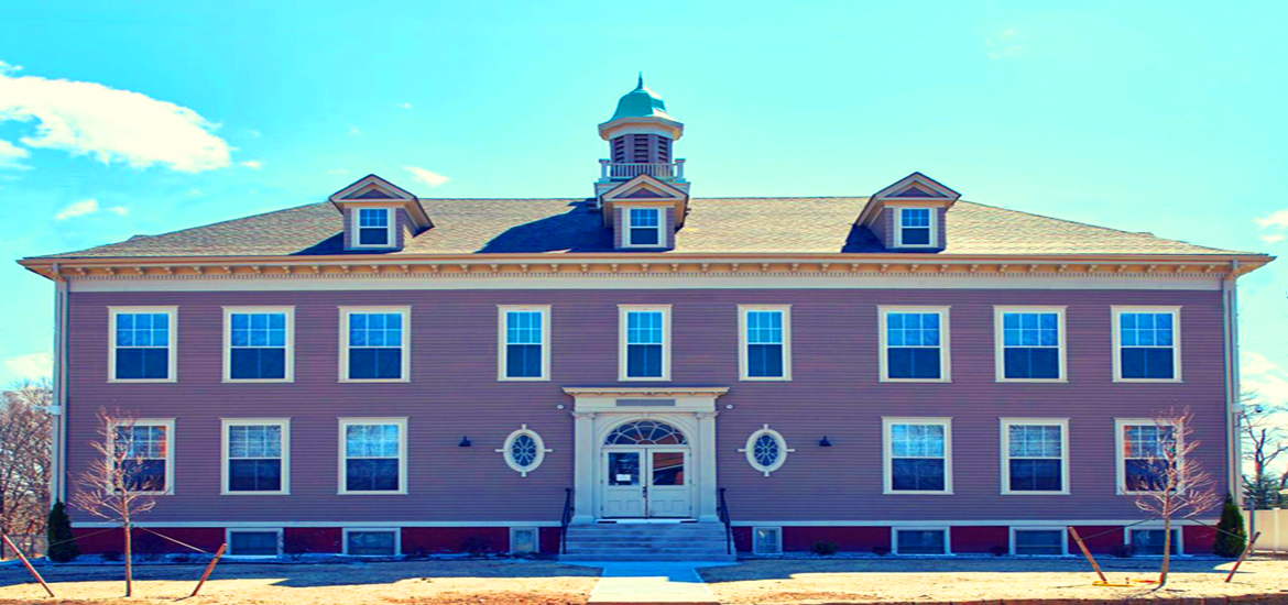 a large pink house with blue sky in the background
