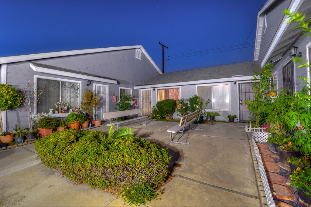 the backyard of a house with a seating area and a bench