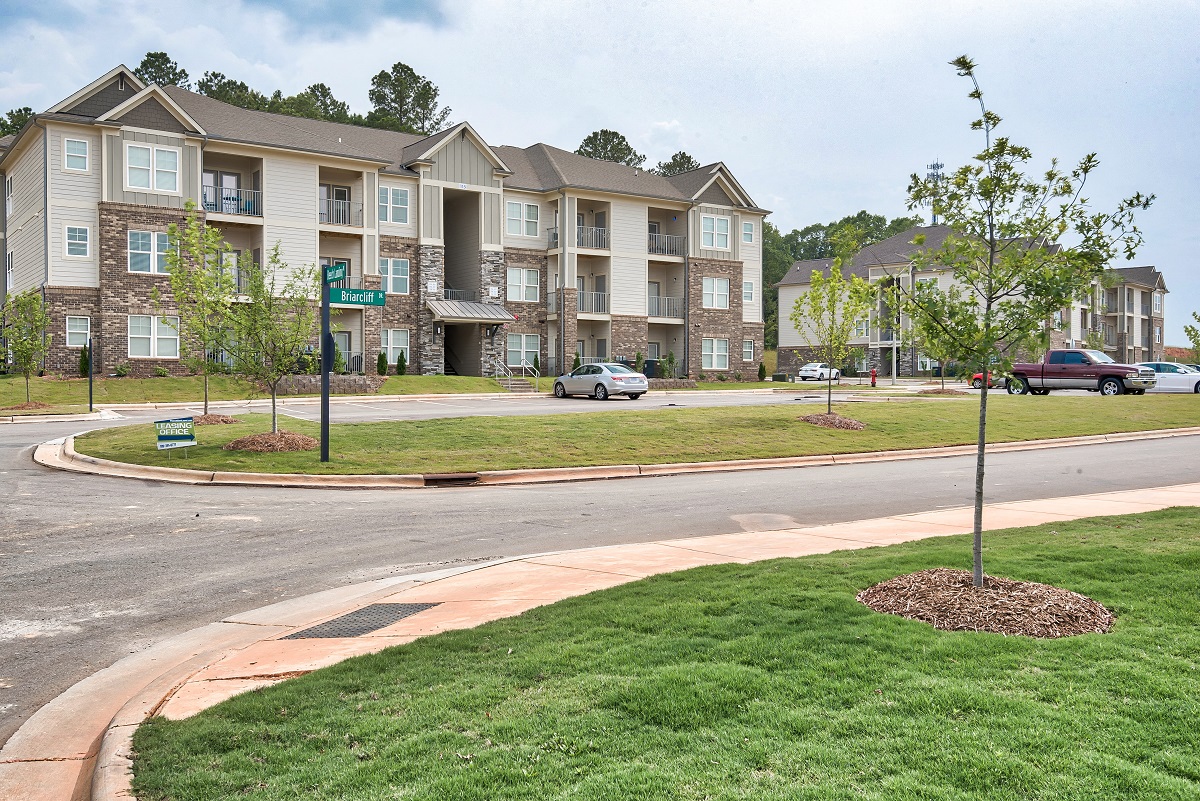 an apartment building on the corner of a street