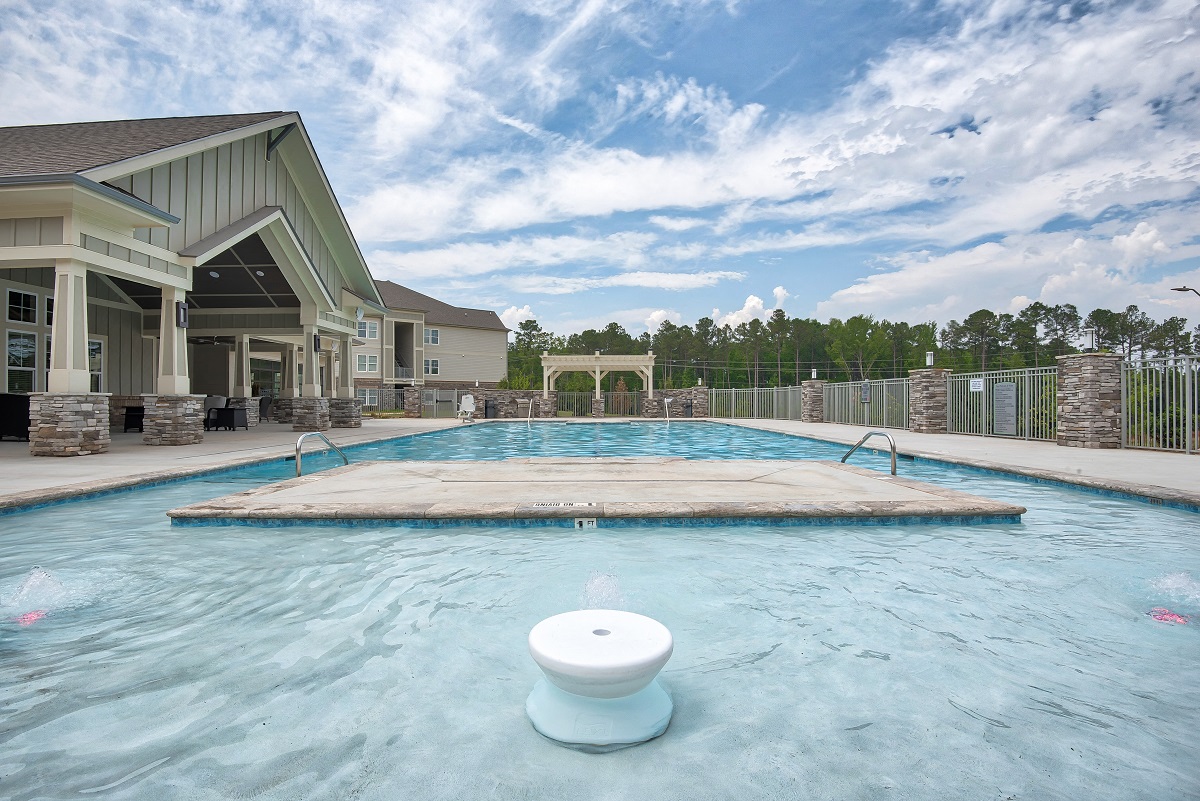 a large pool with a building in the background