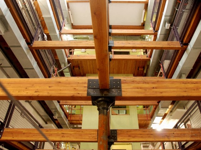 A wooden beam structure with a black box attached to it.