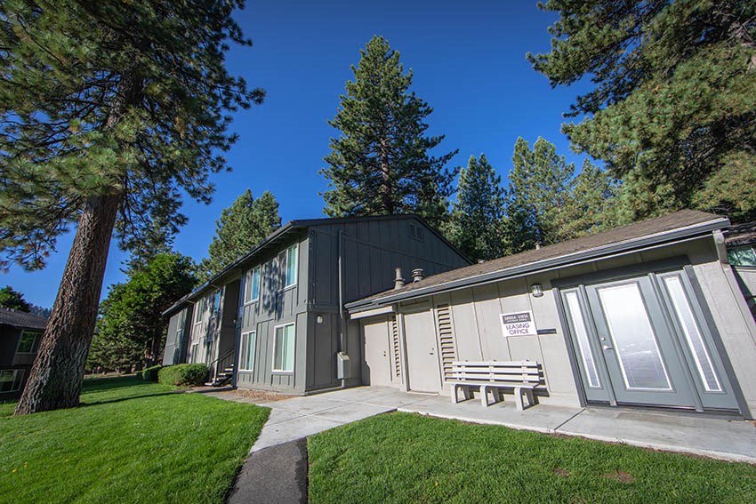 the exterior of a building with a bench in front of it