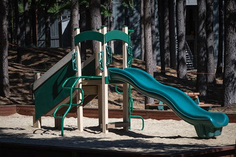 a playground with slides in the sand