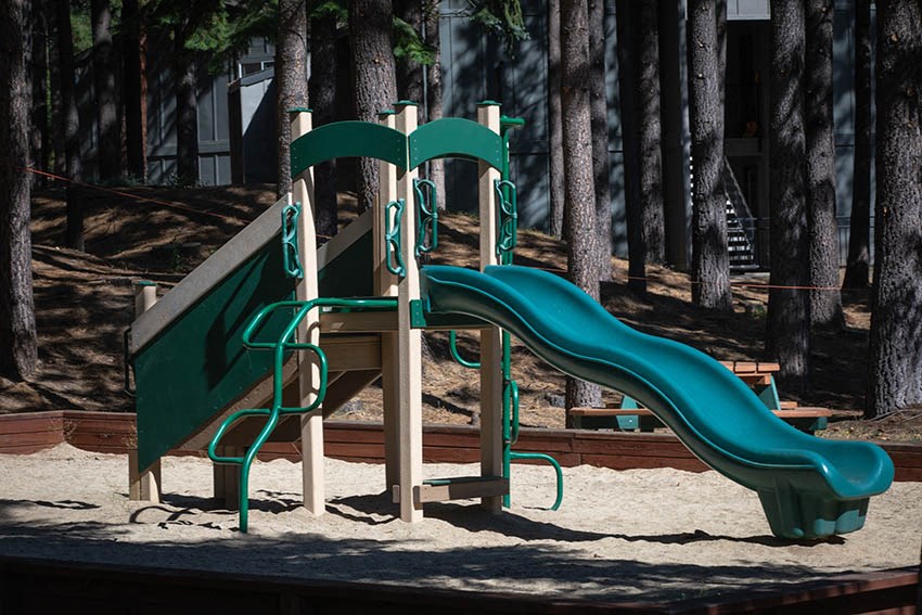 a playground with slides in the sand