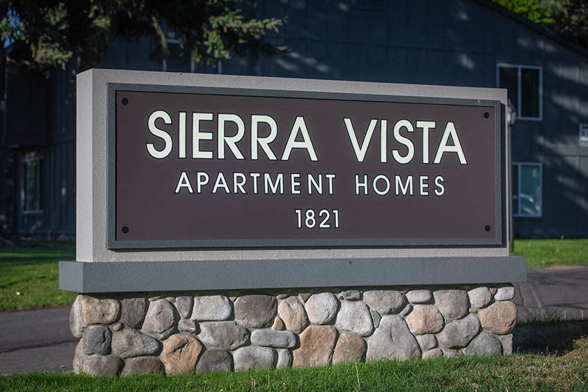 a sign apartment homes in front of a building