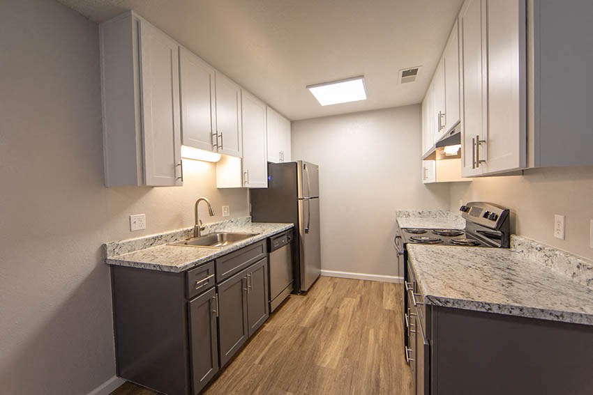 a kitchen with granite counter tops and stainless steel appliances