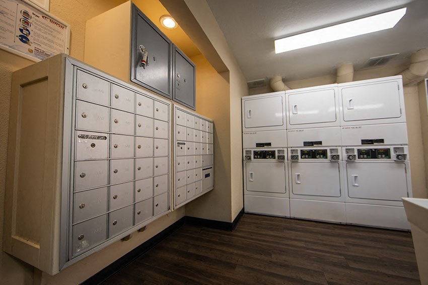a row of white mailboxes in a utility room