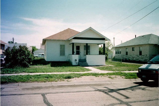 a white house sitting on the side of a street
