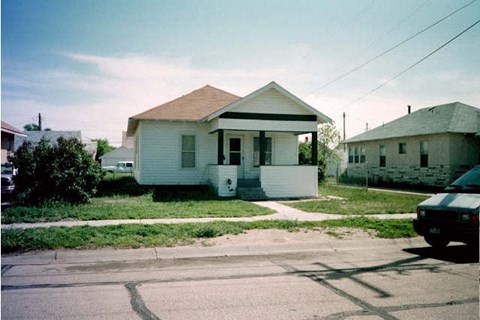 a white house sitting on the side of a street